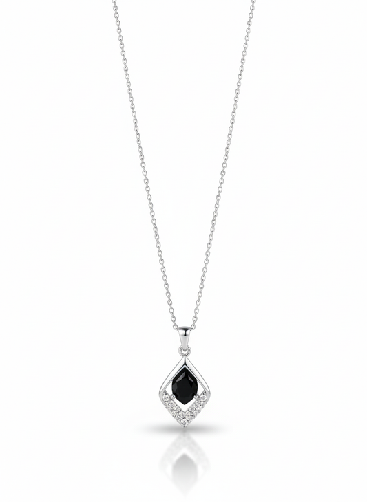 A sterling silver necklace with a stylized heart pendant that has a flame-like accent on one side. The necklace is displayed against a soft neutral background.