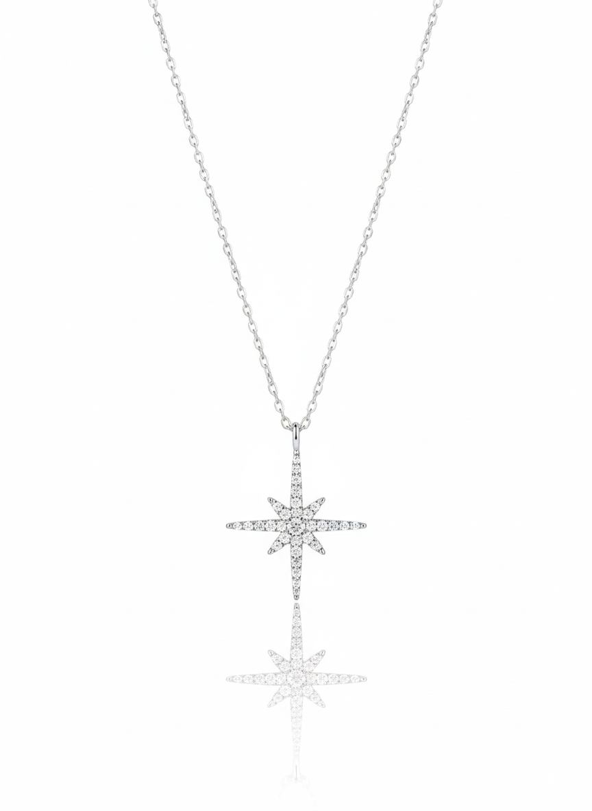 A sterling silver necklace with a minimalist, eye-shaped pendant. The pendant is formed from two separate, curved pieces that create a stylized eye. The necklace is displayed against a soft neutral background.