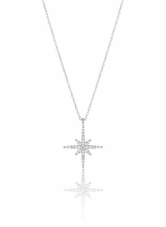 A sterling silver necklace with a minimalist, eye-shaped pendant. The pendant is formed from two separate, curved pieces that create a stylized eye. The necklace is displayed against a soft neutral background.