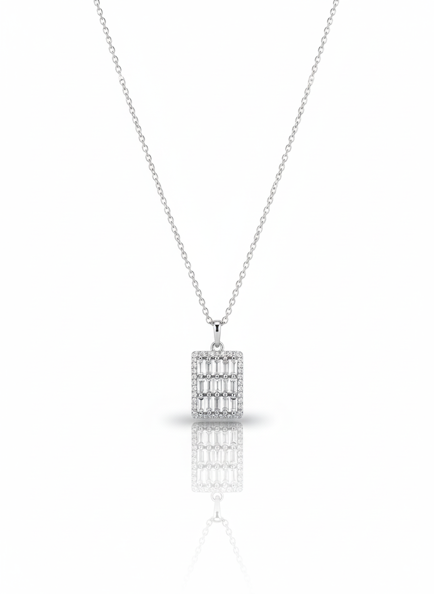A sterling silver necklace with a circular pendant containing a coiled snake cutout. The necklace is displayed against a soft neutral background, with the pendant catching the light.