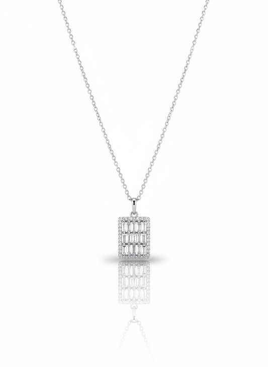 A sterling silver necklace with a circular pendant containing a coiled snake cutout. The necklace is displayed against a soft neutral background, with the pendant catching the light.