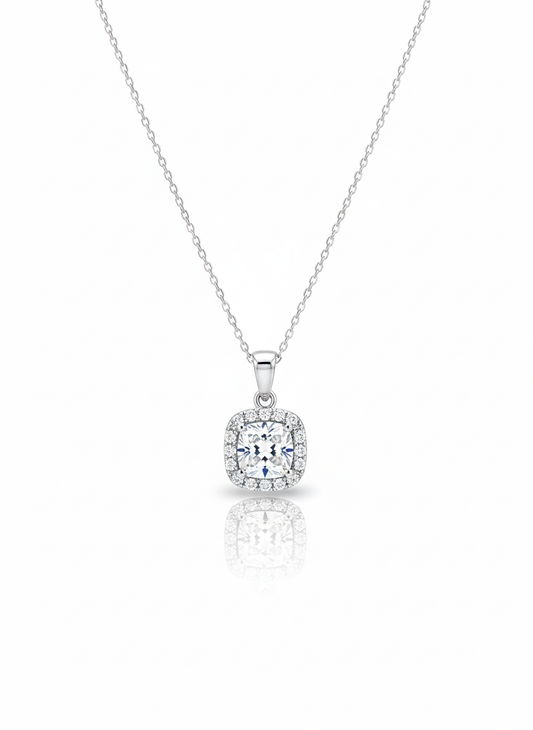 A sterling silver necklace with a solid, round disc pendant that has a rough, stone-like texture. The necklace is displayed against a soft neutral background.
